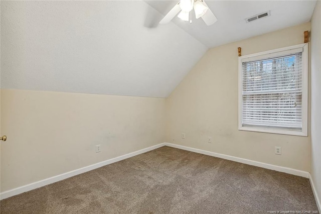 additional living space with ceiling fan, carpet flooring, and vaulted ceiling