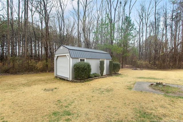 view of outdoor structure with a garage and a lawn