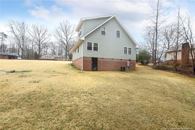 back of property featuring a lawn