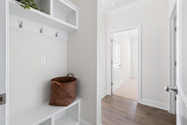 mudroom featuring baseboards, ornamental molding, and wood finished floors