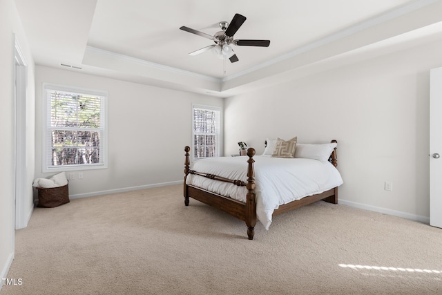 carpeted bedroom featuring ornamental molding, a raised ceiling, visible vents, and baseboards