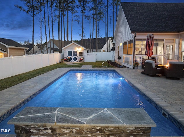 view of pool featuring a fenced in pool, an outbuilding, a patio area, a fenced backyard, and a storage structure