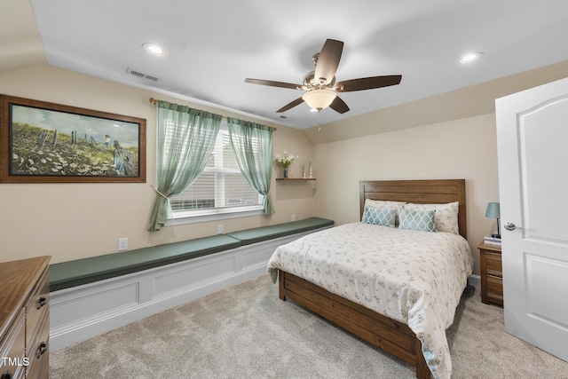 bedroom with lofted ceiling, visible vents, ceiling fan, and light carpet