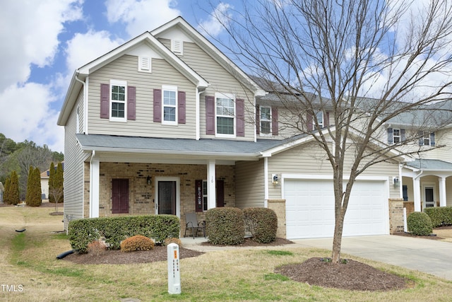 view of front facade with brick siding, a porch, concrete driveway, and a garage