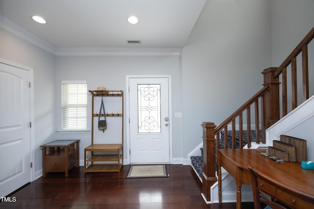 foyer with visible vents, wood-type flooring, ornamental molding, and stairs