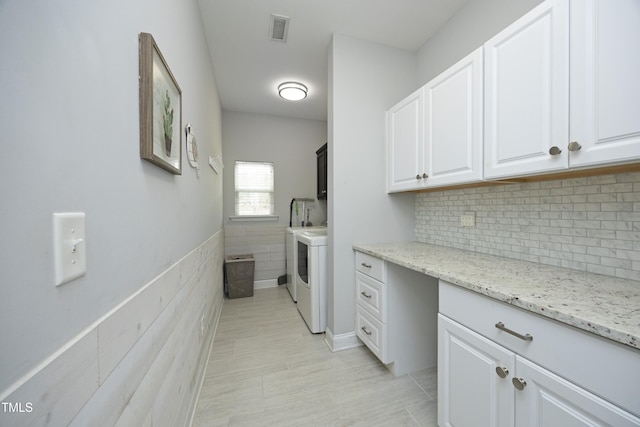 laundry room with visible vents, cabinet space, and separate washer and dryer