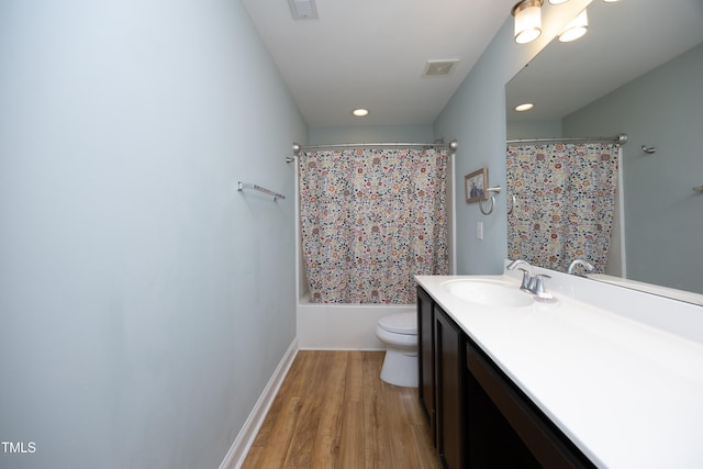 full bath featuring vanity, toilet, wood finished floors, and visible vents