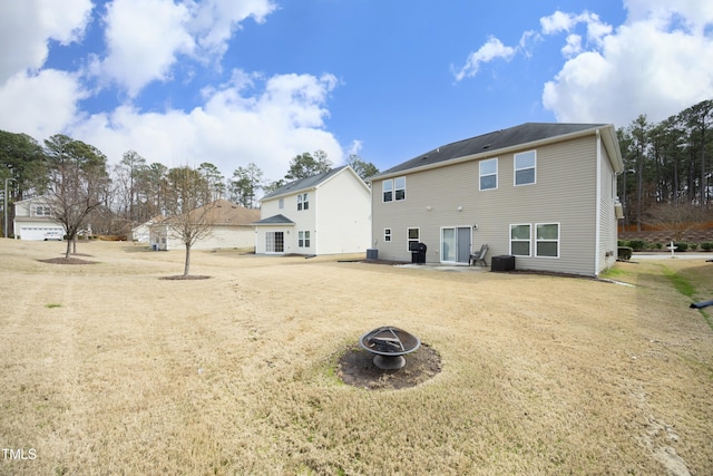 rear view of house with an outdoor fire pit