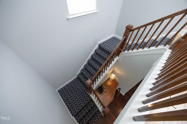 stairs featuring baseboards and wood finished floors