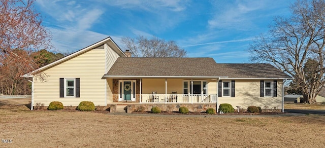 view of front of home with a front yard and covered porch