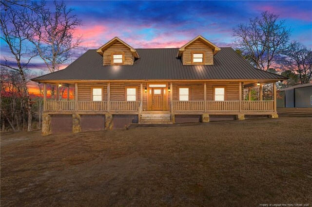 log home featuring a porch