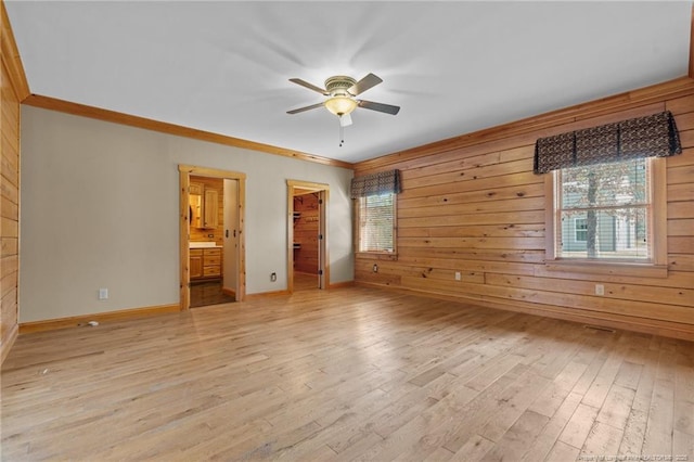526 Grimble Dr, Linden, NC 28356 - unfurnished bedroom with multiple windows, a spacious closet, wooden walls, and light hardwood / wood-style floors