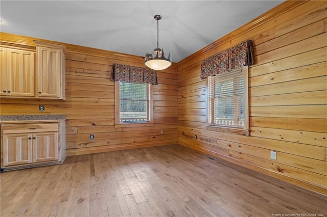 526 Grimble Dr, Linden, NC 28356 - unfurnished dining area featuring wood walls and light wood-type flooring