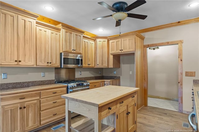 526 Grimble Dr, Linden, NC 28356 - kitchen featuring ceiling fan, appliances with stainless steel finishes, light brown cabinetry, and light hardwood / wood-style flooring