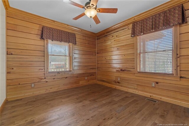 526 Grimble Dr, Linden, NC 28356 - unfurnished room featuring hardwood / wood-style flooring, ceiling fan, and wood walls
