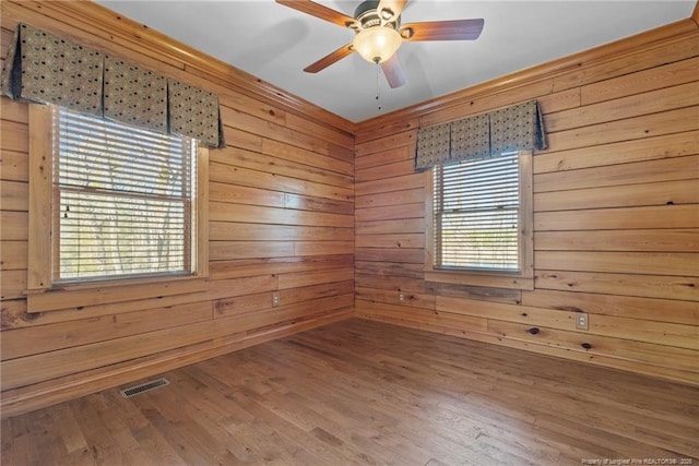 526 Grimble Dr, Linden, NC 28356 - spare room featuring a wealth of natural light, wood-type flooring, and wood walls
