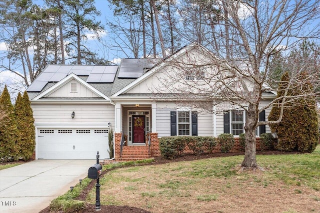 view of front of house with brick siding, solar panels, board and batten siding, a garage, and driveway