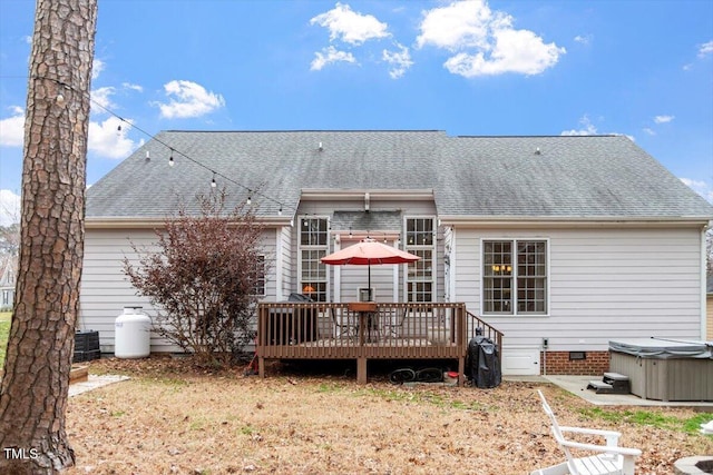 rear view of property featuring a hot tub, a shingled roof, crawl space, a wooden deck, and central air condition unit