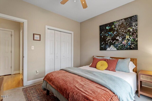 bedroom with ceiling fan, baseboards, a closet, and carpet flooring