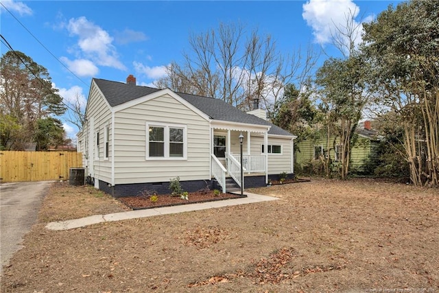 bungalow with central AC unit and covered porch