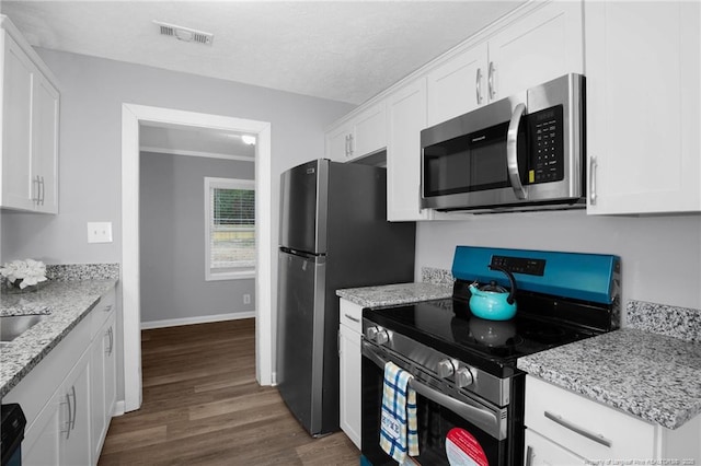 kitchen featuring stainless steel appliances, dark hardwood / wood-style flooring, light stone countertops, and white cabinets