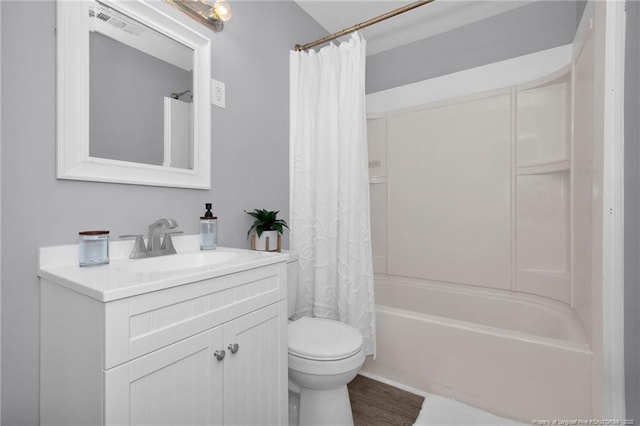 full bathroom with hardwood / wood-style flooring, vanity, toilet, and shower / tub combo