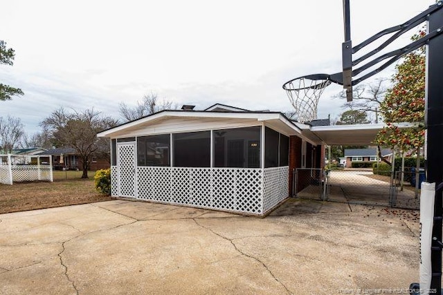 view of home's exterior featuring a carport and a sunroom