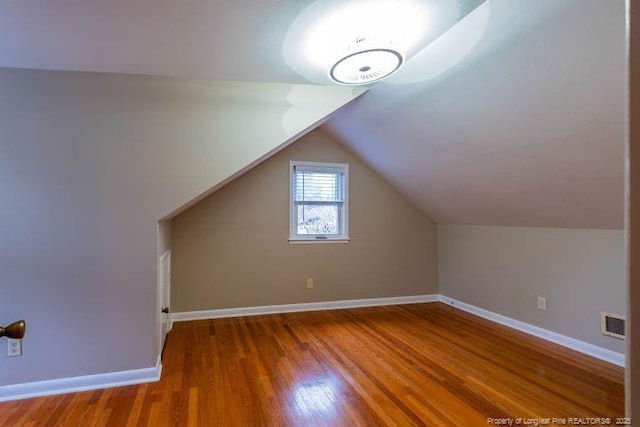 bonus room featuring hardwood / wood-style flooring and lofted ceiling