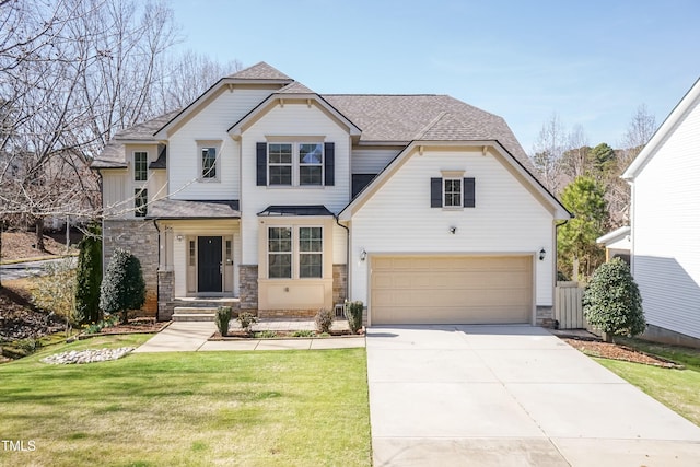 view of front of house with a front yard and a garage