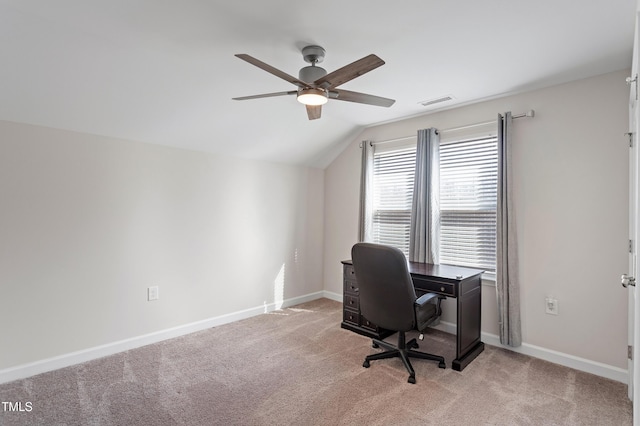 office space featuring light carpet, baseboards, vaulted ceiling, and a ceiling fan