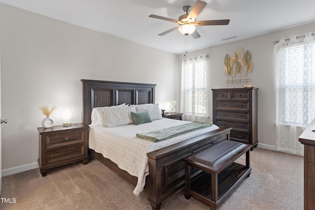 bedroom featuring light carpet, baseboards, visible vents, and ceiling fan