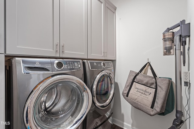 laundry room with cabinet space and washing machine and dryer