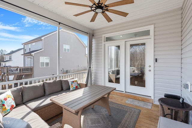 sunroom with a ceiling fan, wooden ceiling, and plenty of natural light