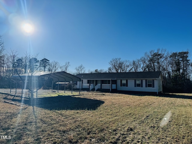 view of front of house with a carport and a front yard