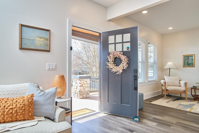 entrance foyer with wood-type flooring and beamed ceiling