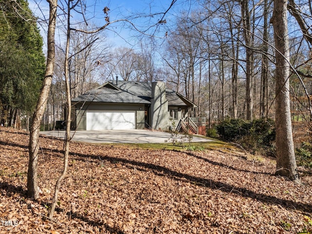 view of yard featuring concrete driveway and an attached garage