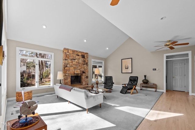 living room with ceiling fan, recessed lighting, a fireplace, baseboards, and light wood finished floors