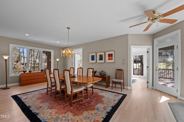 dining room with ceiling fan with notable chandelier, light wood finished floors, recessed lighting, and baseboards