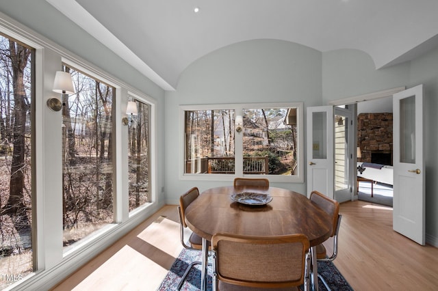 sunroom with lofted ceiling and a healthy amount of sunlight