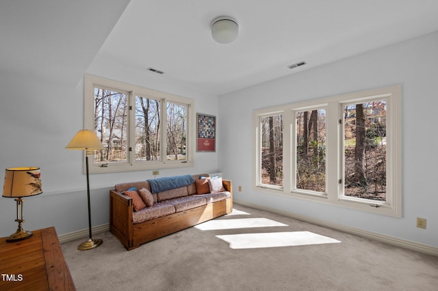 living room featuring light carpet, baseboards, and visible vents