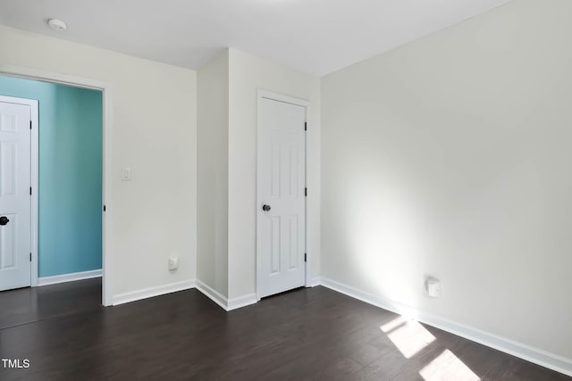 unfurnished bedroom featuring dark hardwood / wood-style floors