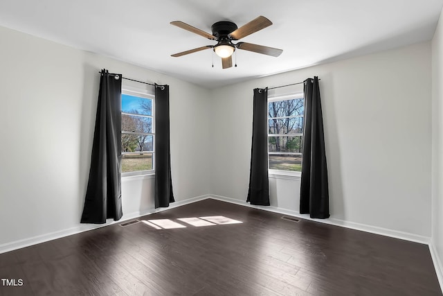 spare room with dark hardwood / wood-style flooring, plenty of natural light, and ceiling fan