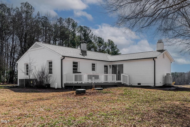 rear view of property featuring a wooden deck, a yard, and cooling unit