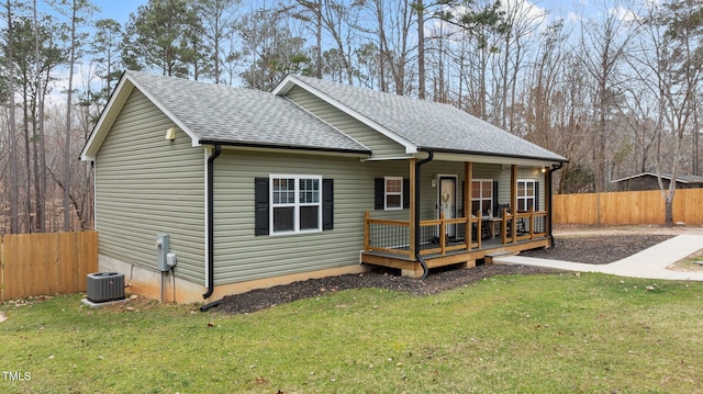 view of front of home featuring a shingled roof, central AC, and fence