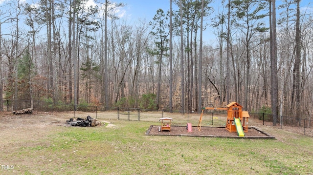 view of yard with fence and a playground