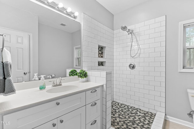 full bathroom featuring a walk in shower, toilet, vanity, and visible vents