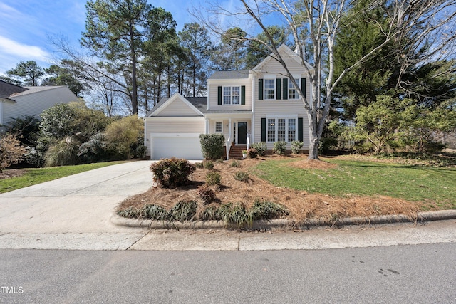 view of front of house with a garage, driveway, and a front lawn