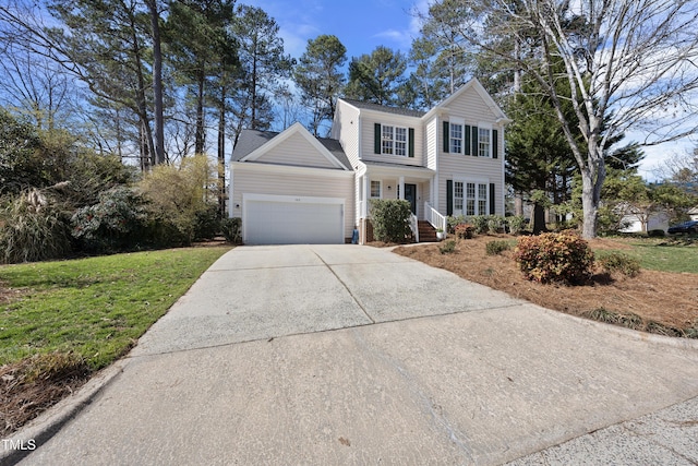 view of front of home featuring a front lawn, concrete driveway, and an attached garage