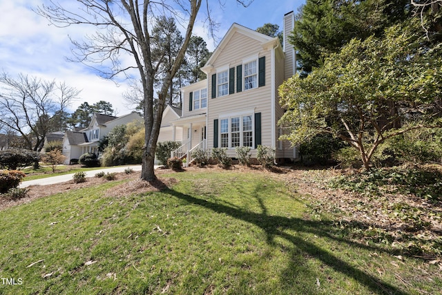 view of front of house featuring a chimney and a front yard