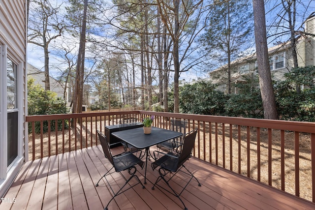 wooden terrace featuring outdoor dining space